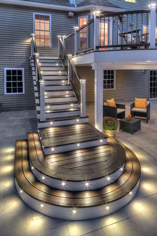 A decking staircase at night illuminated by LED lights