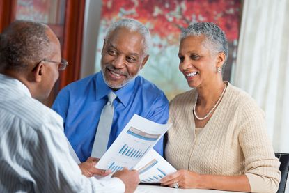 A couple meets with a financial planner to discuss annuities. 