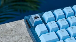 A glacier blue Corsair K65 Plus wireless mechanical keyboard for Mac