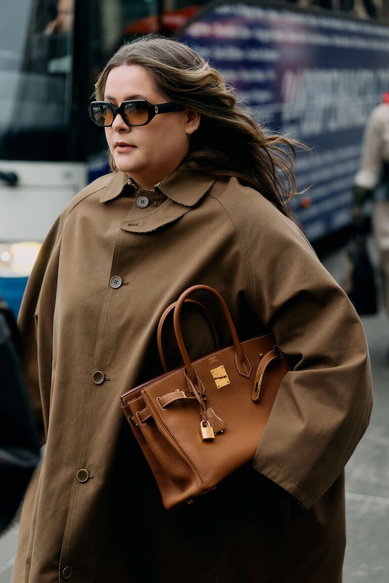 a woman wears a Birkin