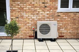 hybrid heat pump outside of brick house