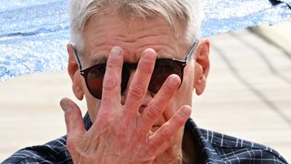 US actor Harrison Ford adjusts his sunglasses as he poses during a photocall for the film &quot;Indiana Jones and the Dial of Destiny&quot; during the 76th edition of the Cannes Film Festival in Cannes, southern France, on May 18, 2023. (Photo by Stefano RELLANDINI / AFP) (Photo by STEFANO RELLANDINI/AFP via Getty Images)