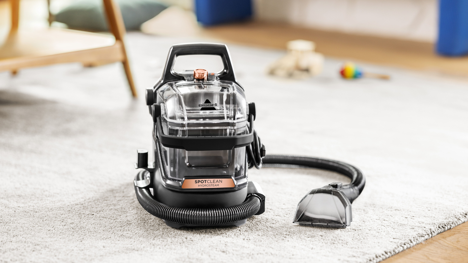 The Little Green®HydroSteam® Pet Portable Carpet Cleaner on a Cream rug. 