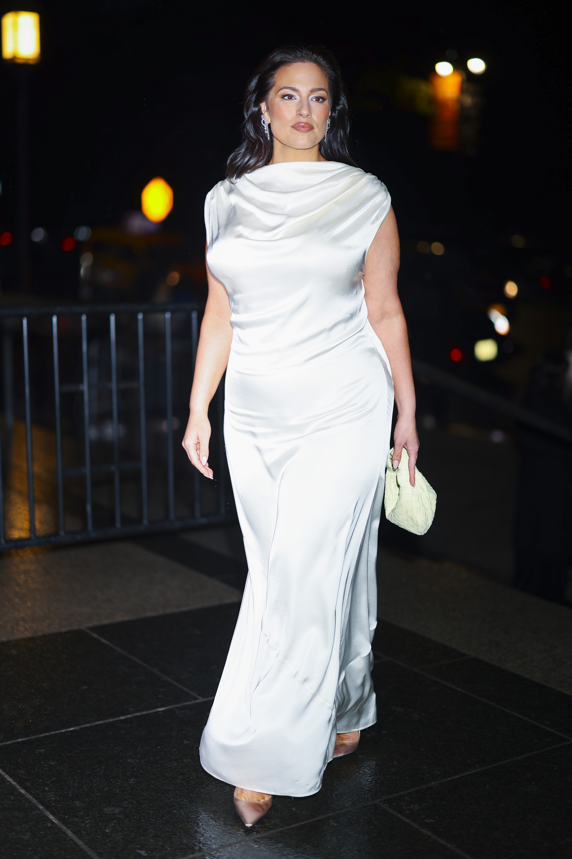 Ashley Graham arrived at the CFDA awards wearing a cream satin dress with light light satin heels and a butter yellow bag.