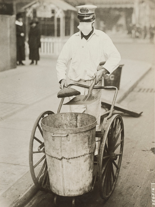 A street sweeper in New York wearing a protective mask