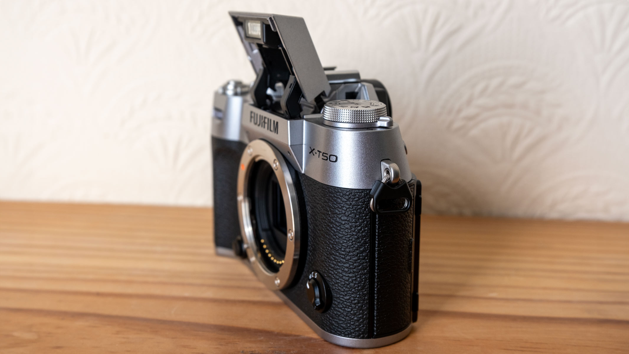 The Fujifilm X-T50 with the flash enabled