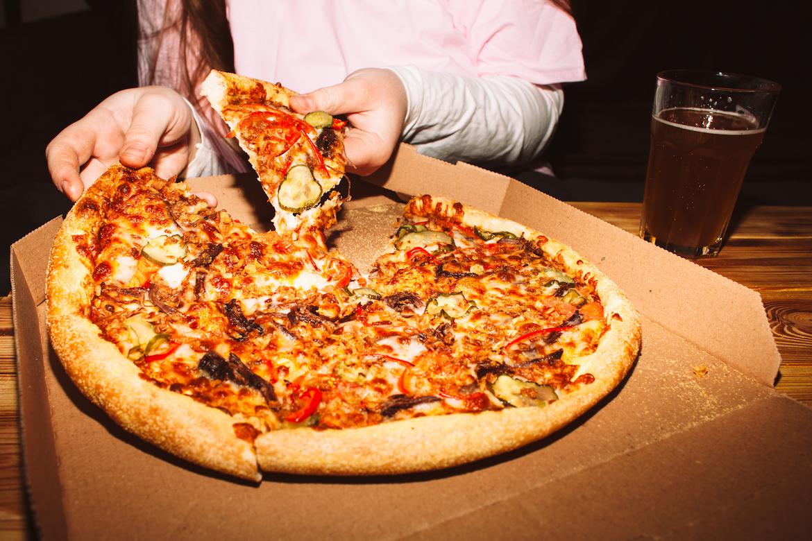 Student eating pizza