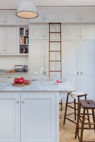 Studio style kitchen island leg system in an un-lacquered aged