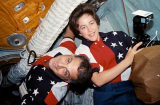 NASA astronauts David Wolf and Wendy Lawrence are pictured in the docking module between the Mir Space Station and the space shuttle Atlantis on May 1, 1997, inthe early moments of joint activities between the STS-86 and Mir-24 crews.