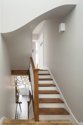 curved white ceiling over a wooden staircase