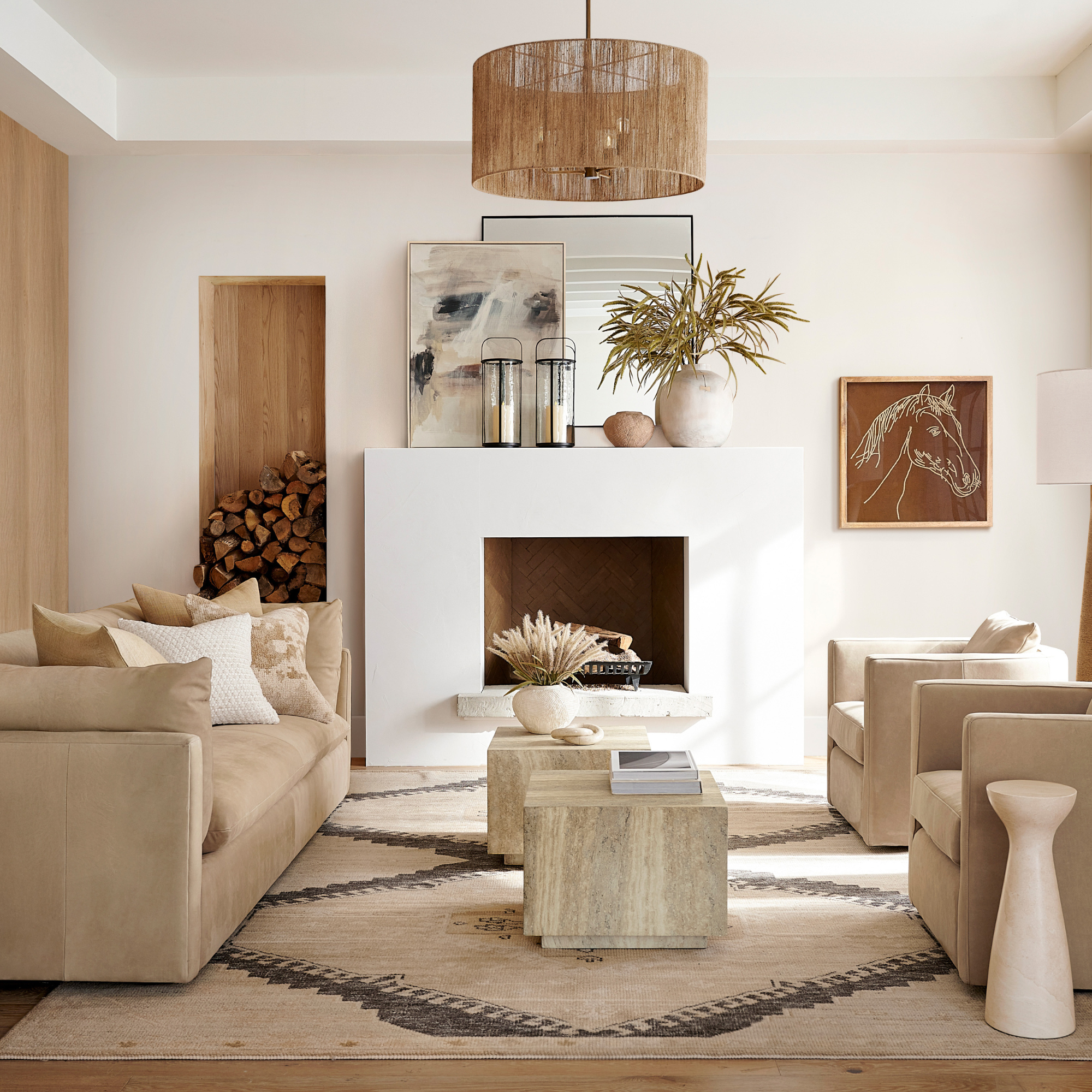 Neutral living room with beige sofas, a large cream rug and pale wood coffee table.