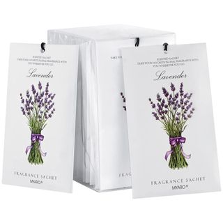 White lavender sachets with a bunch of lavender on the front tied with a purple ribbon