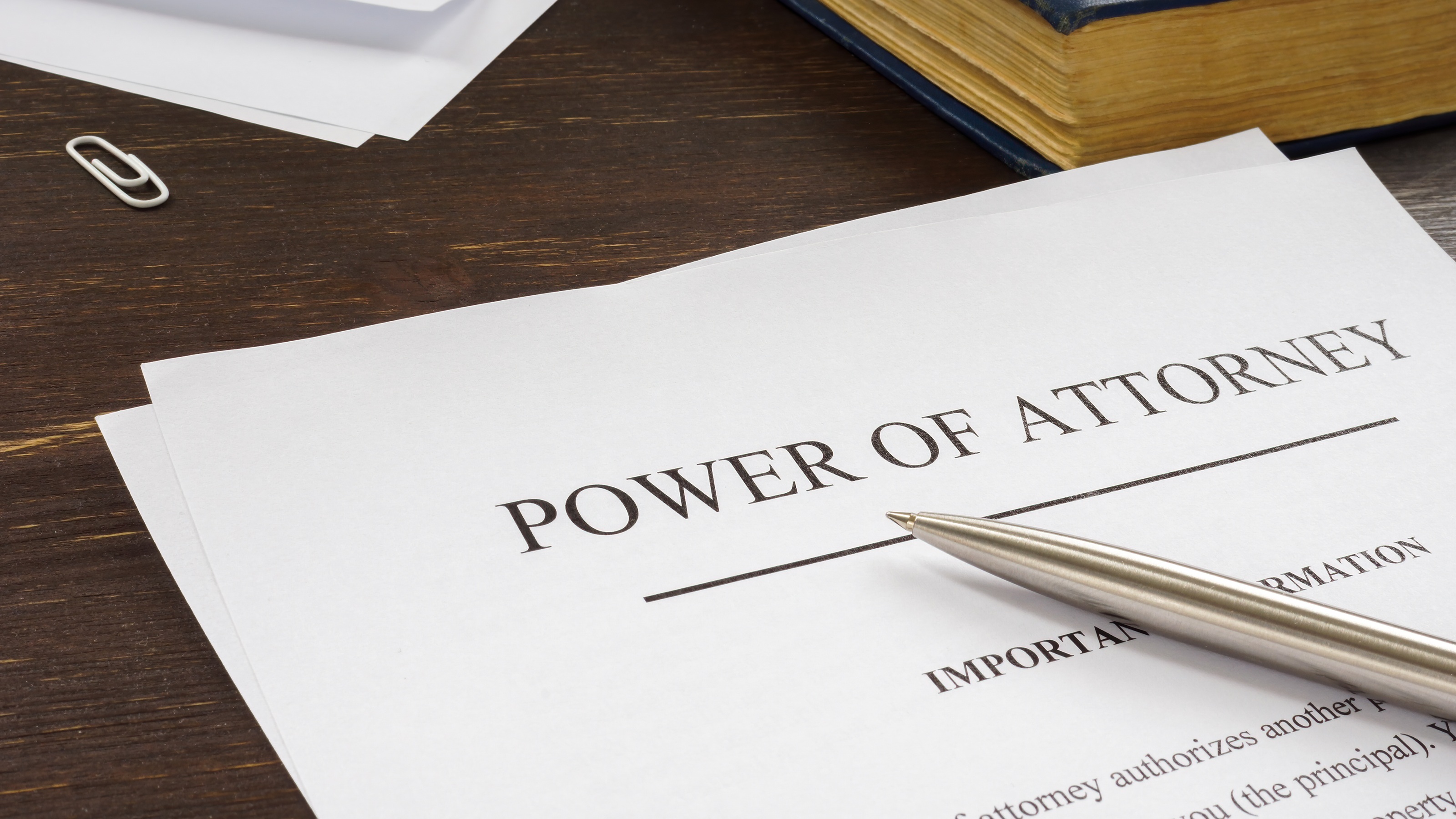 A pen on top of paperwork that says Power of Attorney on it.