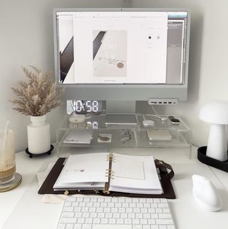 White minimal desk with raised computer