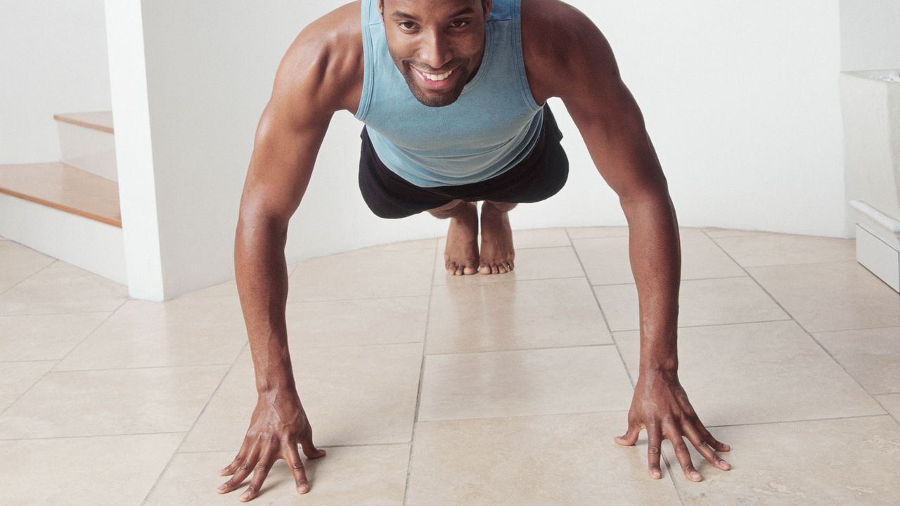 Man doing push ups in his home