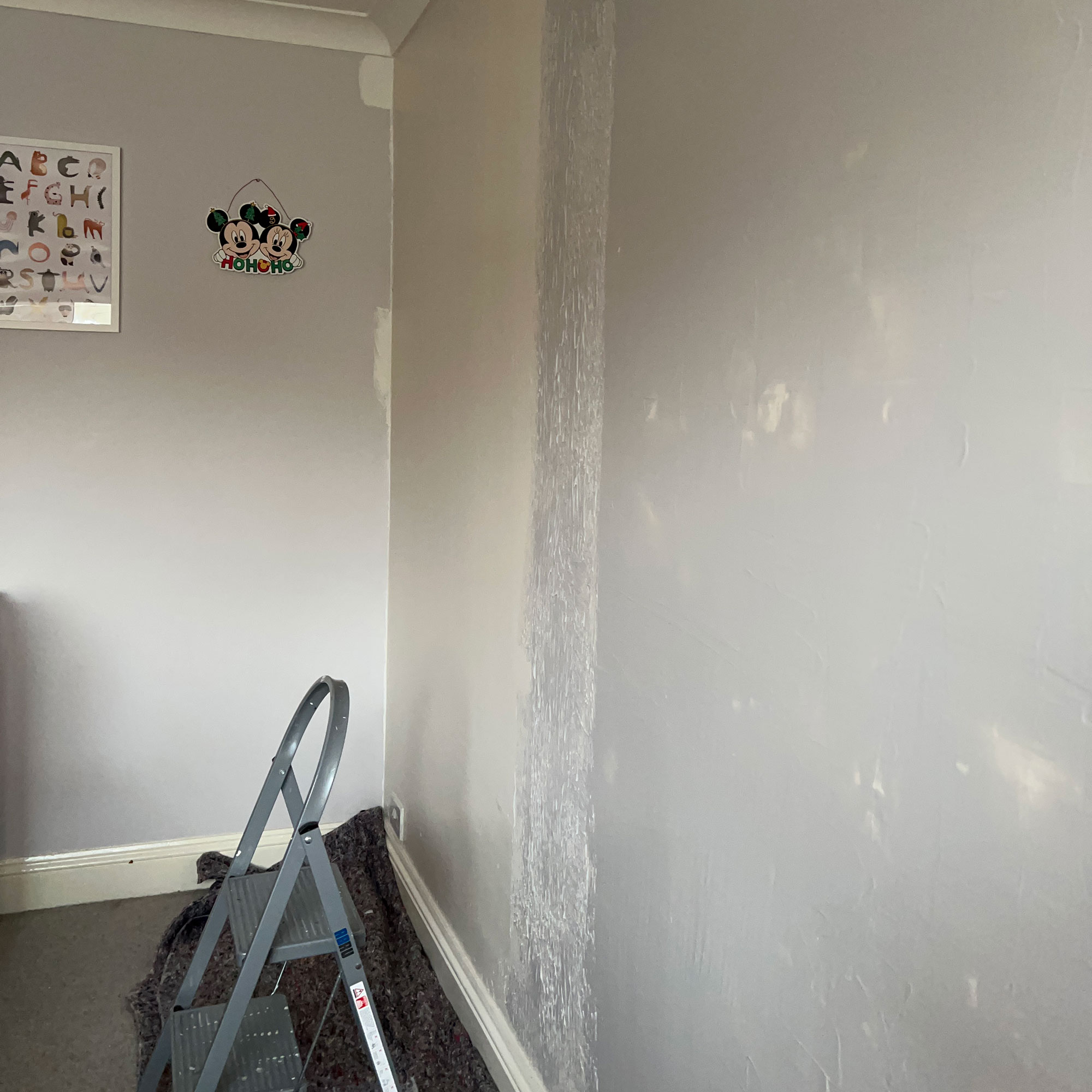 Stepladder in room with walls mid-renovation