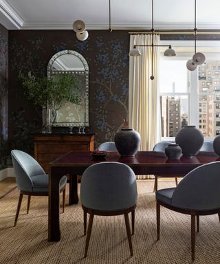 Dining room with blue wallpaper and dark wooden dining table and blue chairs