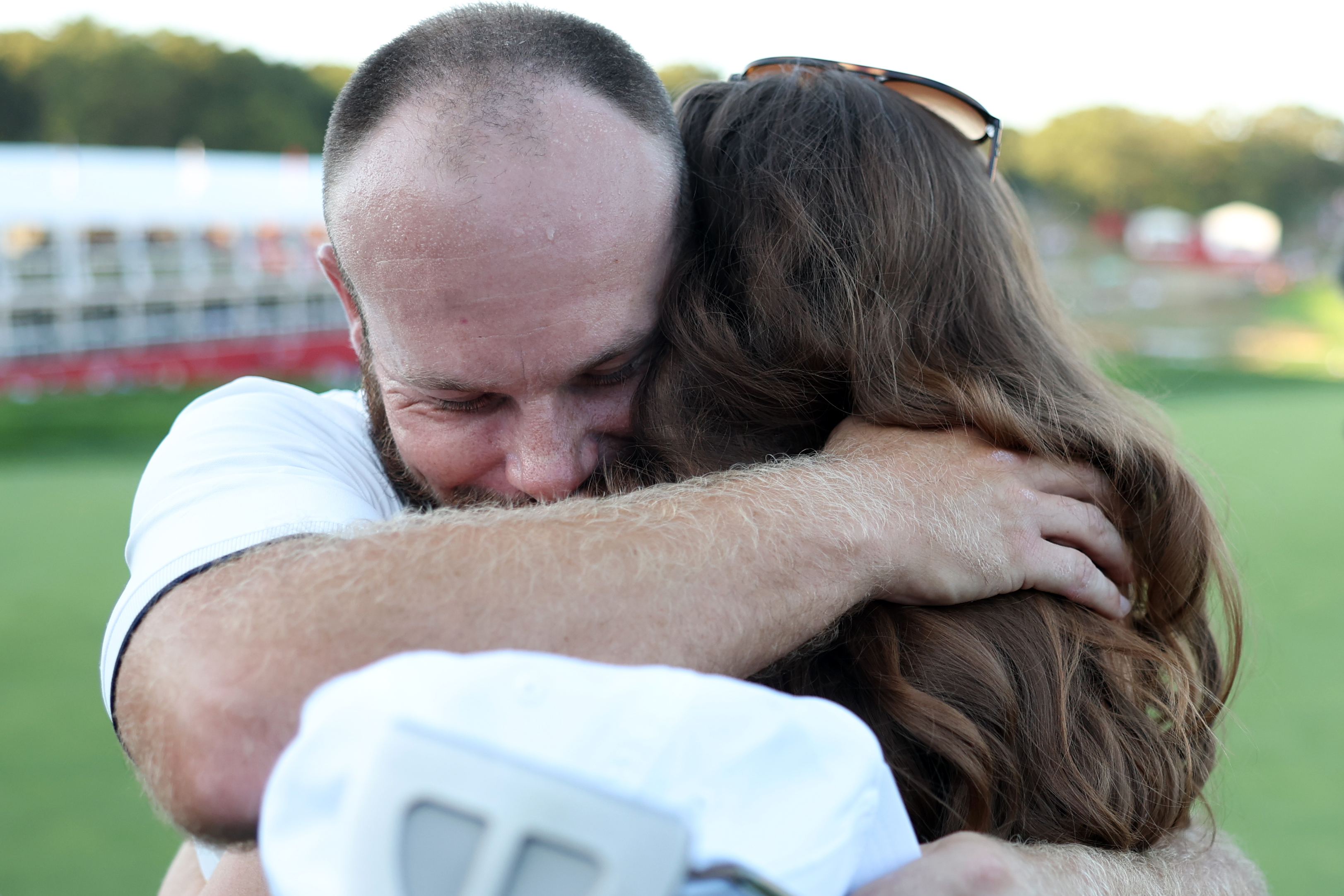 Tyrrell Hatton hugs his wife, Emily after holing the winning putt at the 2025 Ryder Cup
