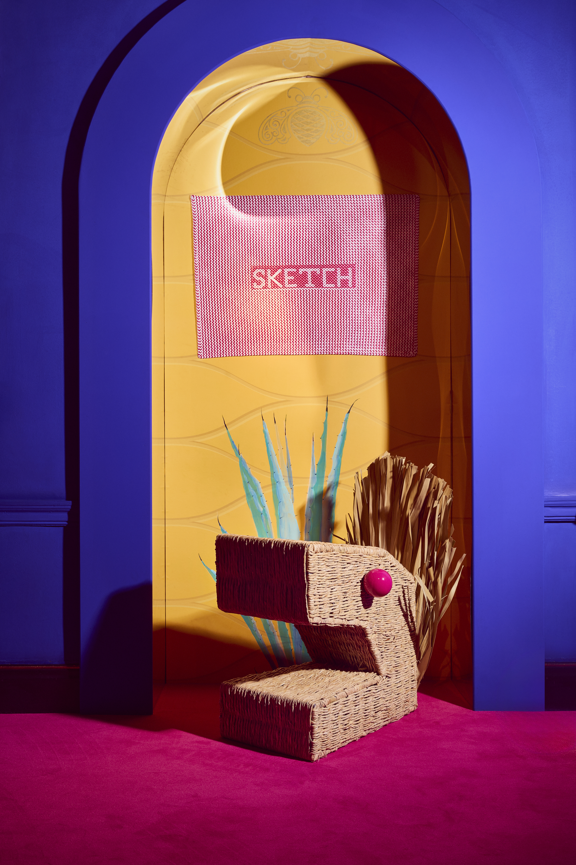 Installation view of ¡hola, London!, a whimsical art installation made of whicker-made furniture molded after dragons, cacti, and fantastical creatures, at sketch London.