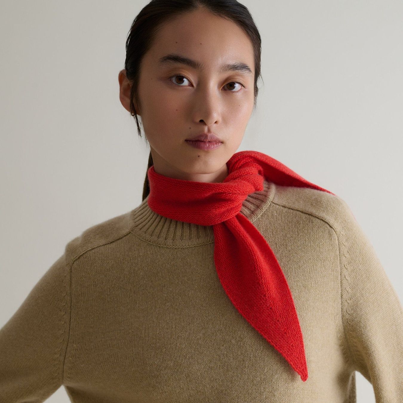 a model wearing a rise &amp; fall cashmere neckerchief