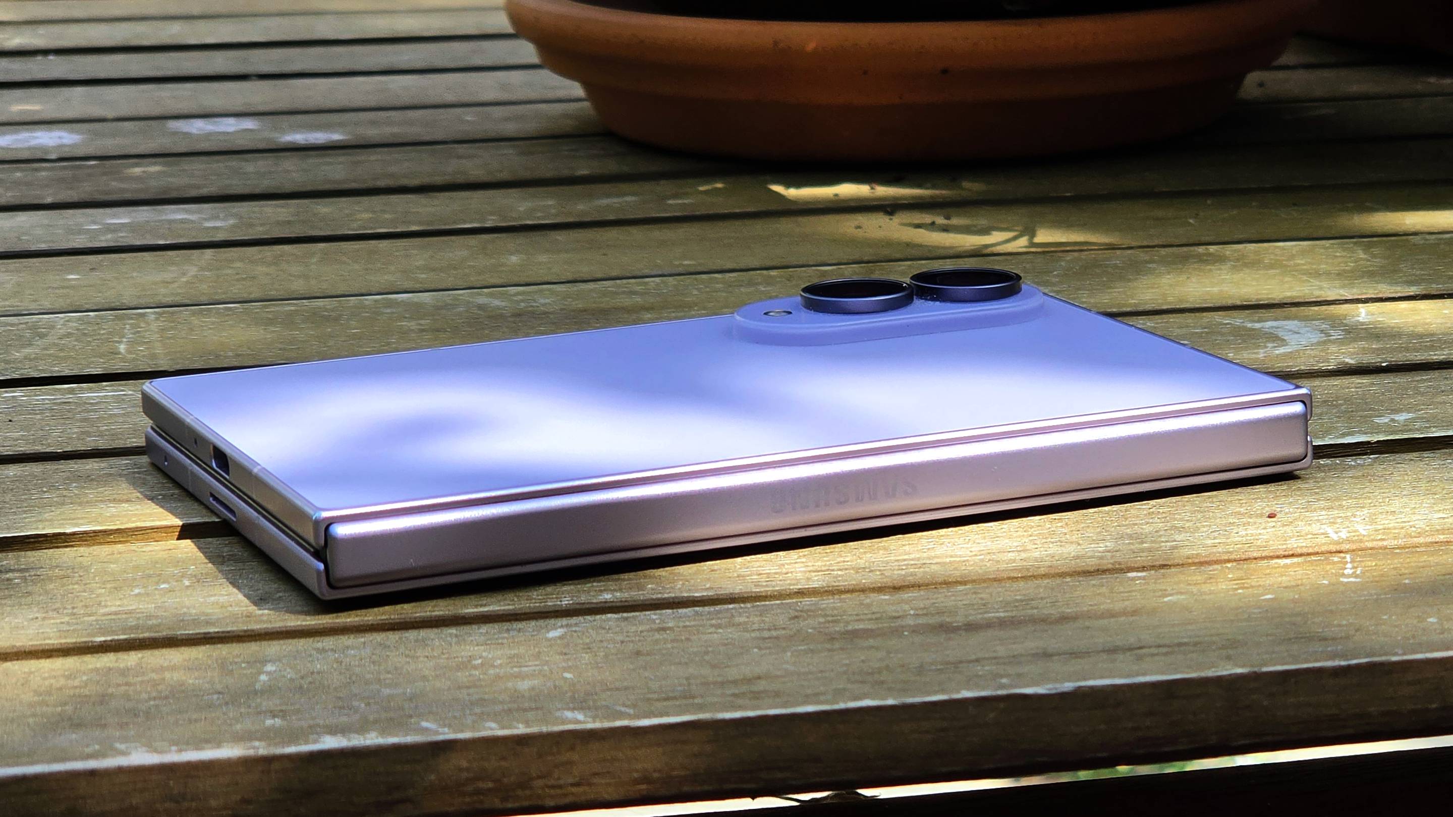 The Samsung Galaxy Z Fold 8 on a wooden table, face down.