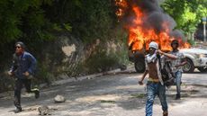 Protesters torch Haitian government car in Port-au-Prince