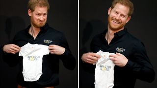 Prince Harry holding a babygrow