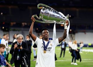 Vinicius Junior celebrates with the trophy after Real Madrid's victory over Liverpool in the 2022 Champions League final