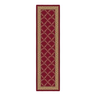 A dark red runner rug with a gold trellis design in the middle and a gold patterned border
