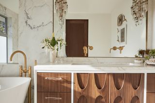 A bathroom with wooden vanity storage