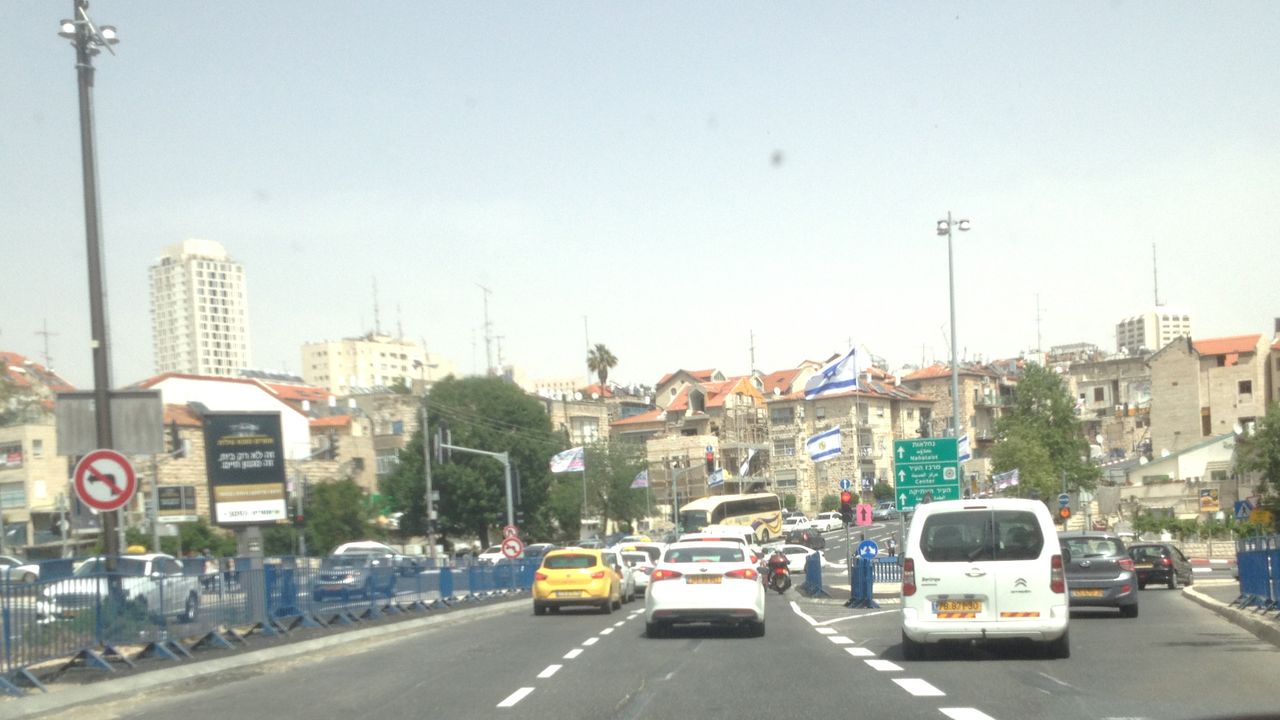 The road heads upwards towards the narrow city streets