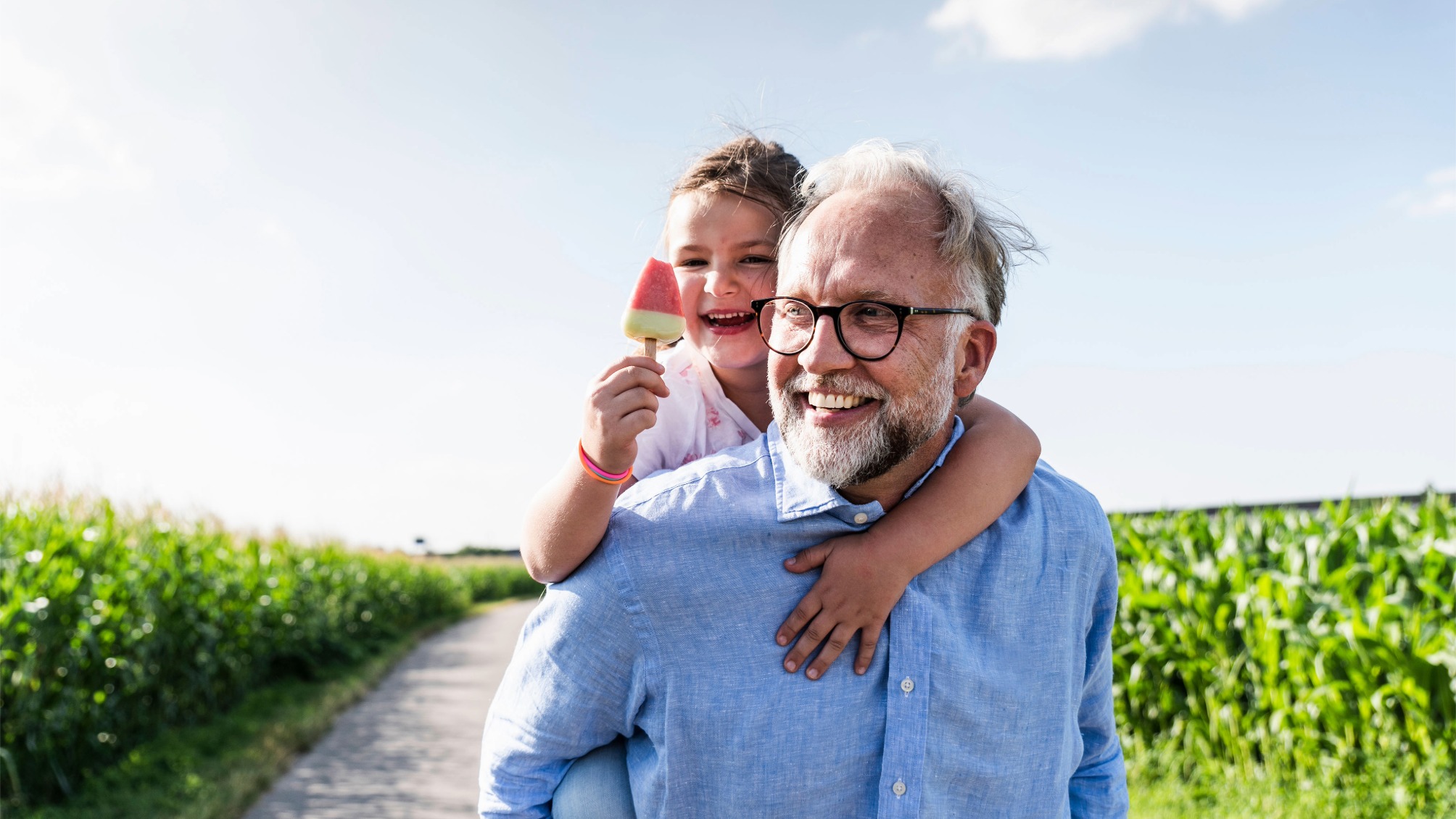 Grandfather giving granddaughter a piggyback