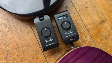 A Fender Mustang Micro and Mustang Micro Plus next to each other on a wooden floor