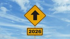 Close-up of a finger touching a loading bar transitioning from 2025 to 2026, representing vision, innovation, and the future. Ideal for illustrating technological progress and forward-thinking concept