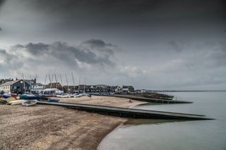 A picturesque shot of Whitstable Bay, with dark clouds and rippling sea.
