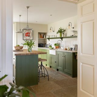 green country kitchen with island with wooden top