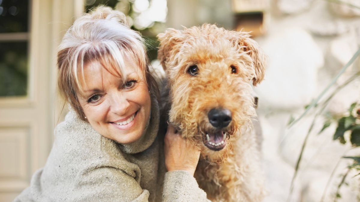 Woman hugging Airedale Terrier