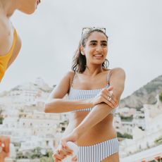 women applying the best sun creams on the beach