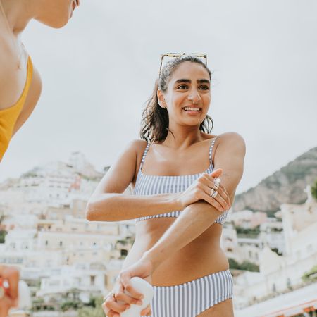 women applying the best sun creams on the beach