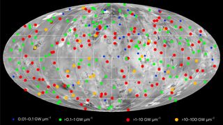 a map of a grey moon dotted with red dots indicating volcanoes