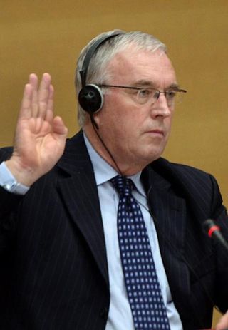 UCI President Pat McQuaid takes the oath before speaking at the French Senate hearing into anti-doping