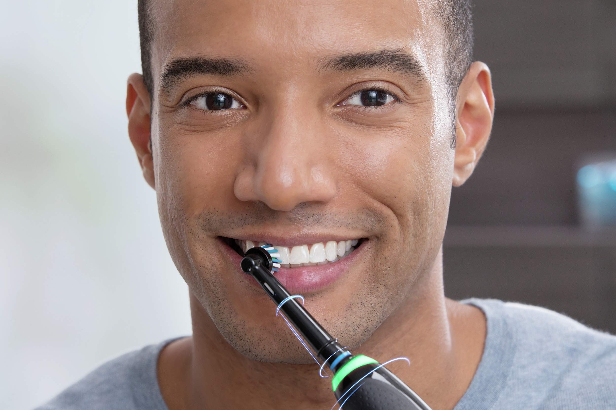 Man uses Oral-B Genius X electric toothbrush
