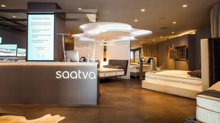 Image of a Saatva Viewing Room where a range of Saatva mattresses and sleep products are on display and available to test before buying