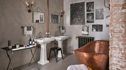 Industrial grey bathroom with copper freestanding bath