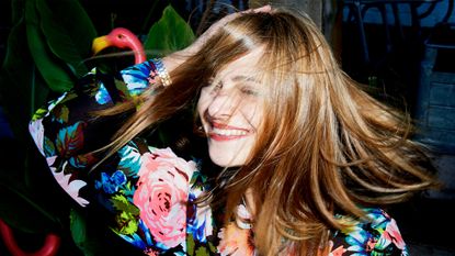 woman smiling with windswept hair - stock photo