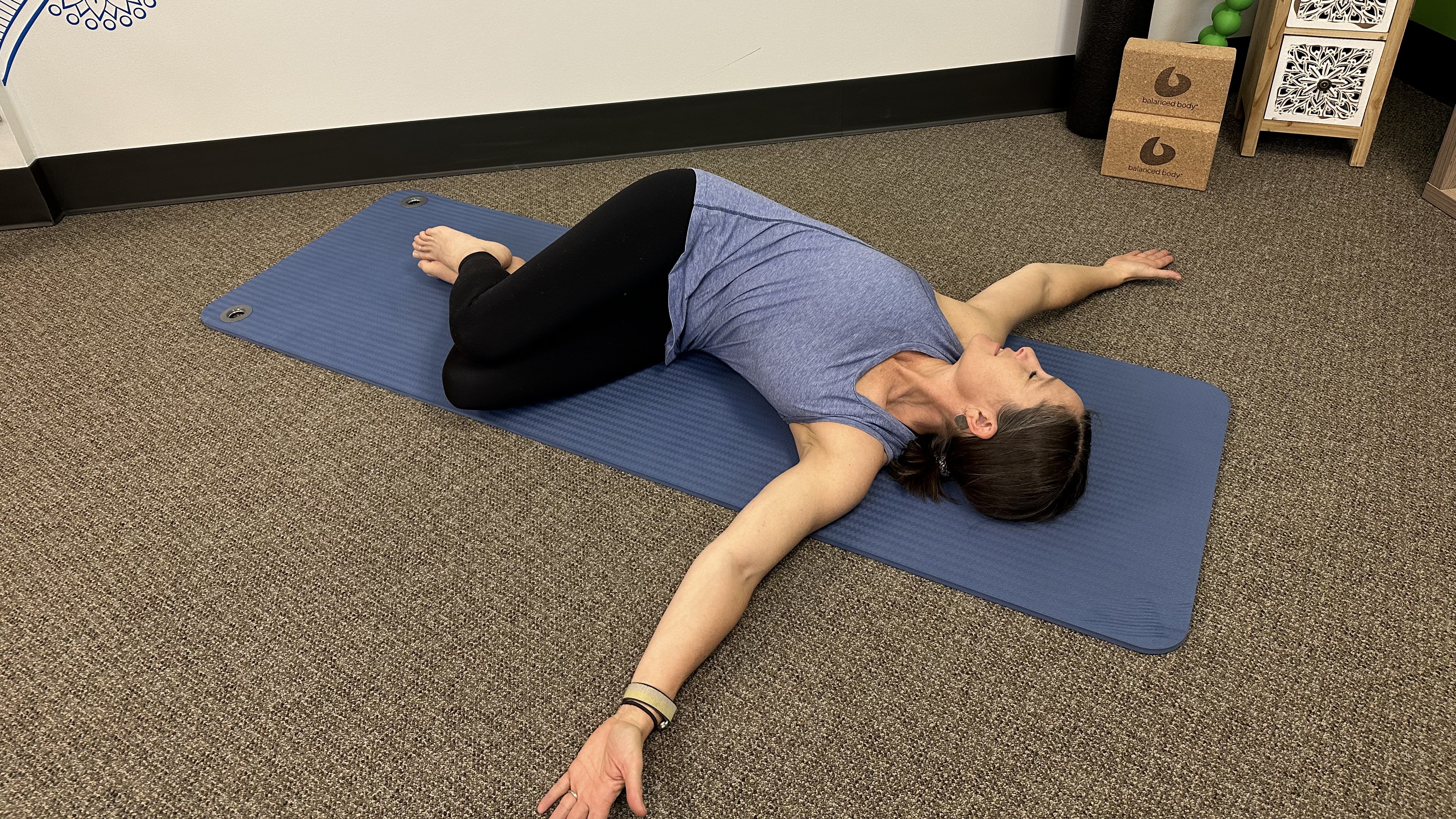 Woman demonstrates back stretch