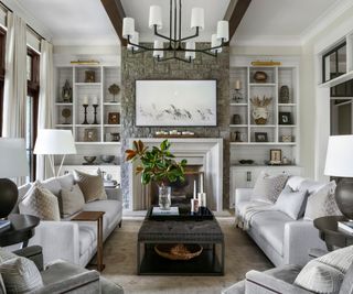 Stone fireplace, white mantle, white sofa