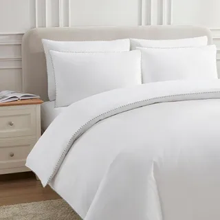 A bed with white bed linen