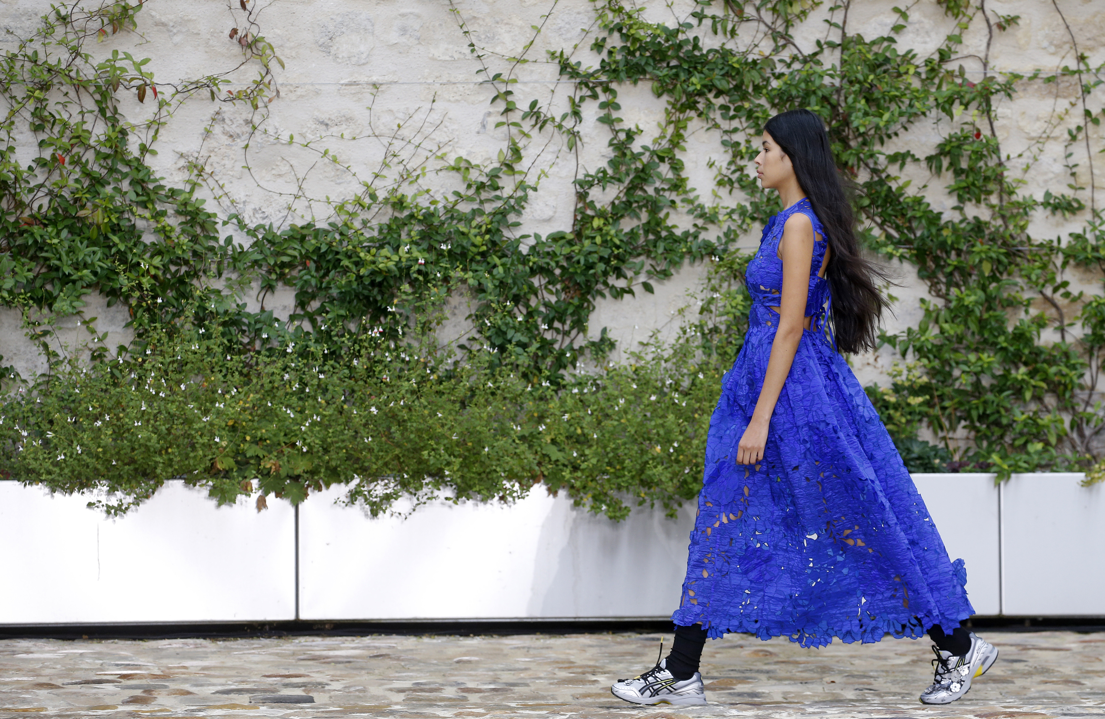 a model wearing a cecilie bahnsen dress on the runway at fashion week