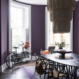 dining room with purple walls and dining table with chairs